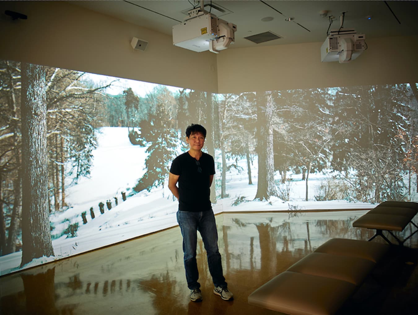 Photographer Paige Strobel visited several local galleries for her LP photo essay, ‘Galleries Adapt to Pandemic While Artists Continue to Create.’ Pictured is Jawshing Arthur Liou in front of his high-definition, multichannel video installation, ‘House of the Singing Winds,’ which shows the changing seasons at the historic home and studio of Hoosier painter T.C. Steele. The work is currently on view at the Sidney and Lois Eskenazi Museum of Art. | Photo by Paige Strobel