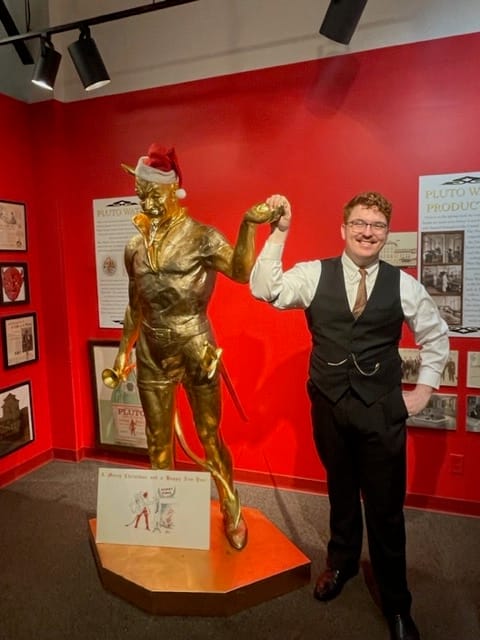 Kenton Allbright, assistant director of the French Lick Museum, with a statue of Pluto. | Photo by Laurie D. Borman