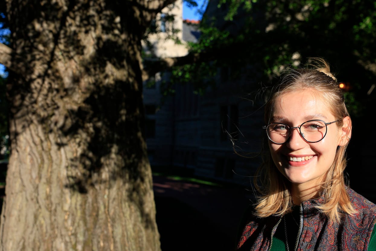 Working on the IU tree survey fostered Hannah Gregory’s love of trees. Here she’s in front of one of the ginkgo trees planted in 1896 outside of Maxwell Hall. | Photo by Jeremy Hogan