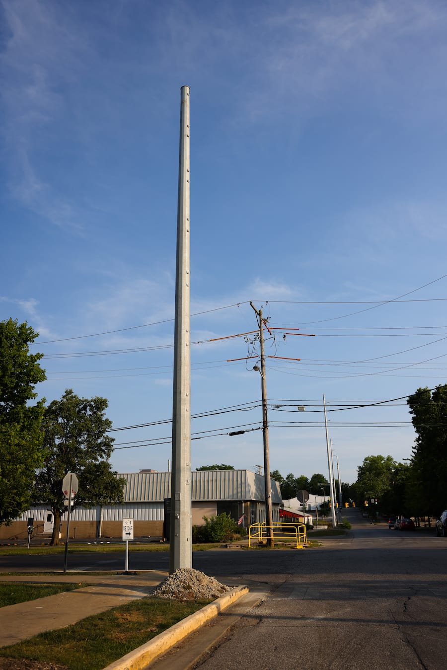 Old and new power transmission poles and lines in downtown Bloomington. Jeff Danielson, vice president of advocacy for the Clean Grid Alliance, said, “It’s time for Americans to think about our grid as an interstate superhighway and build it so we can move power around.” But now, said Danielson, “our grid is like a balkanized country.” | Photo by Benedict Jones