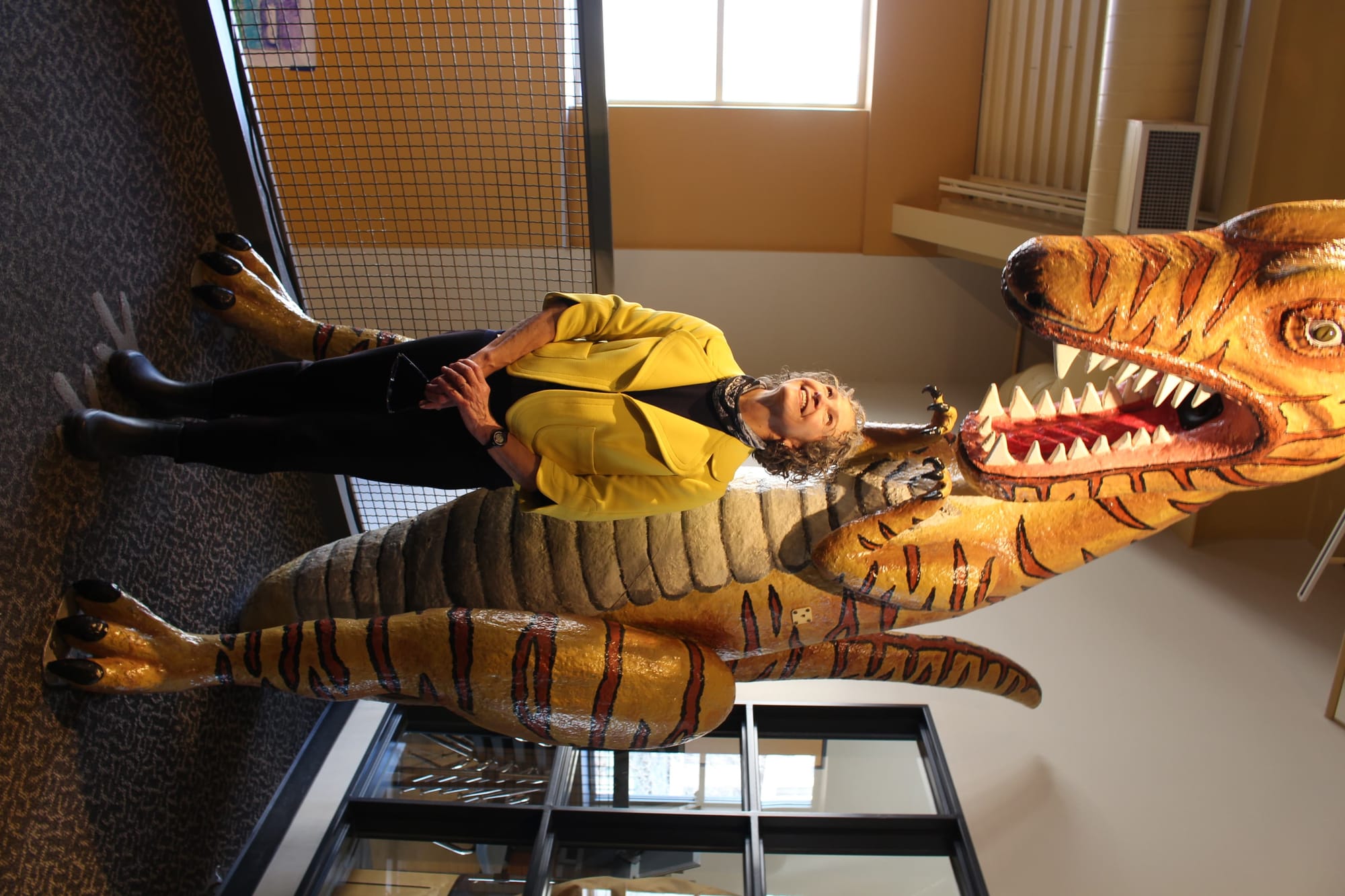 Karen Jepson-Innes, who recently retired as executive director of WonderLab, demonstrates the WonderSaurus, which measures height with an ultrasonic sensor. | Photo by Trung Le