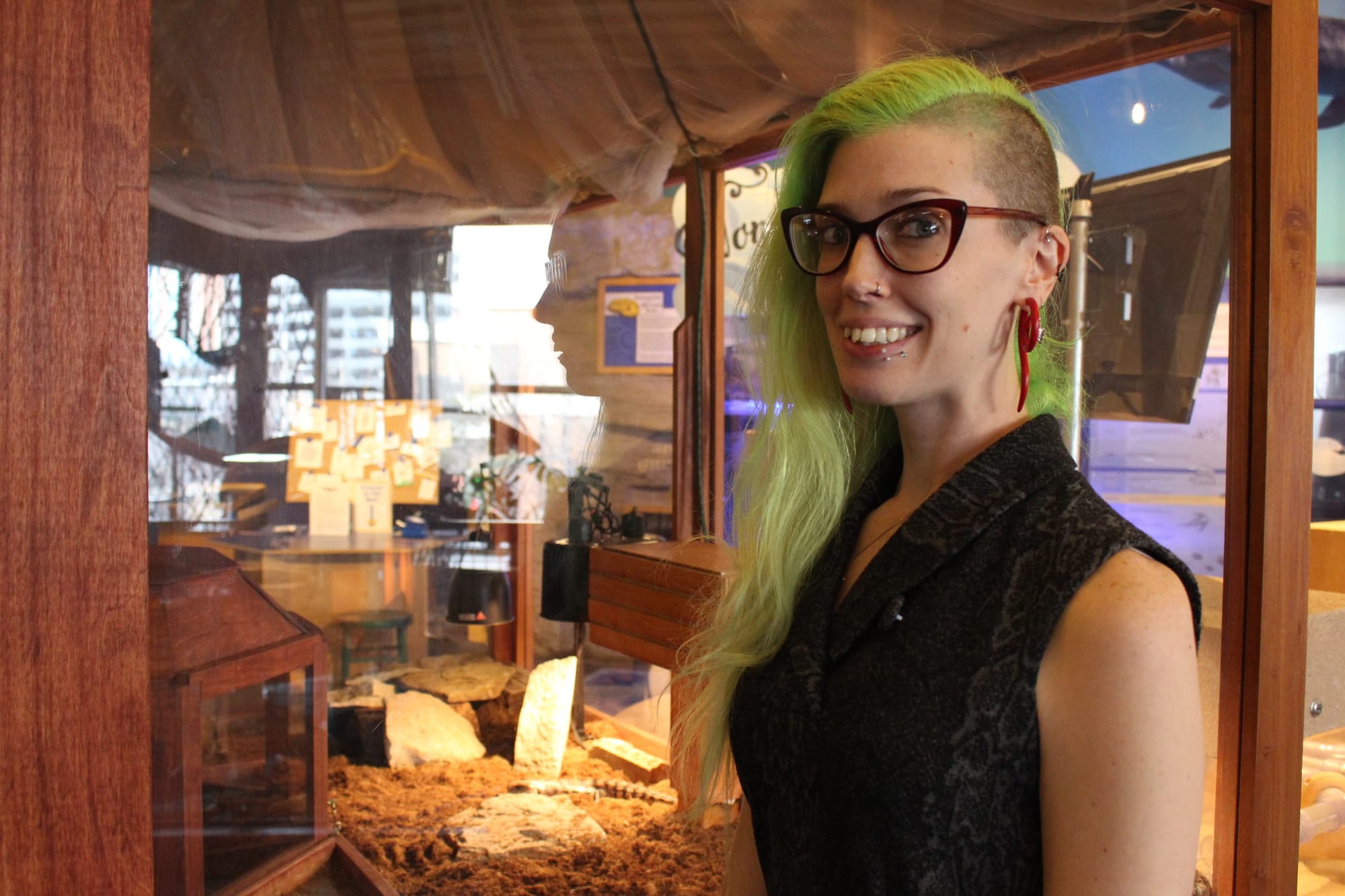 Samantha Couch, WonderLab's exhibits and facilities director, with the lizard exhibit she designed. | Photo by Trung Le