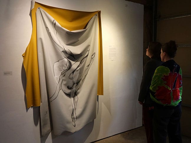 Gallery visitors view one of Cooper Pennington’s drawings on vinyl at the I Fell. She says the exhibition was the first time she “intentionally highlighted my drawings.” | Photo by Claude Cookman