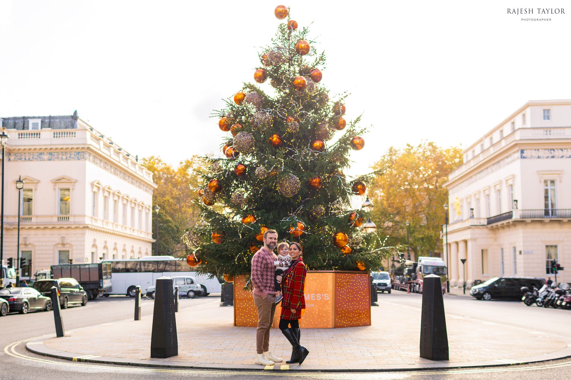 The St James's Christmas Tree on Waterloo Place with The Snelling Family (L) Institute of Directors (formerly the United Service Cub) and (R) The Athenaeum in the distance: © Rajesh Taylor