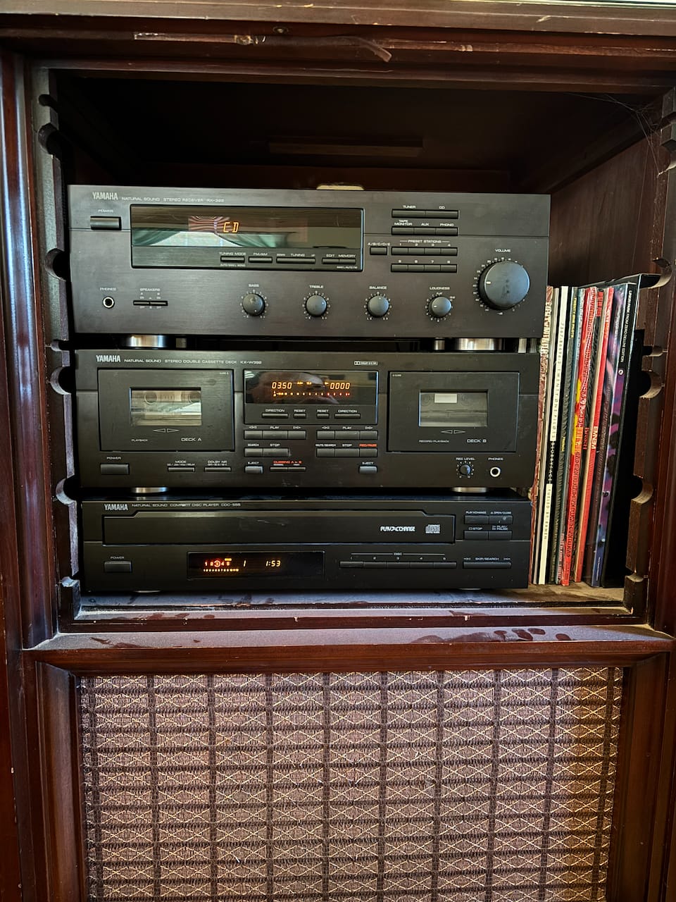 A 1990s Yamaha stereo system complete with receiver, cassette deck, and 5-disc cd player.