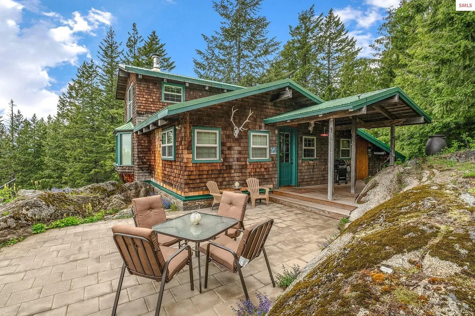 ## Warm wood siding, cedar shakes, and that bold green roof—feels grounded and cozy already.