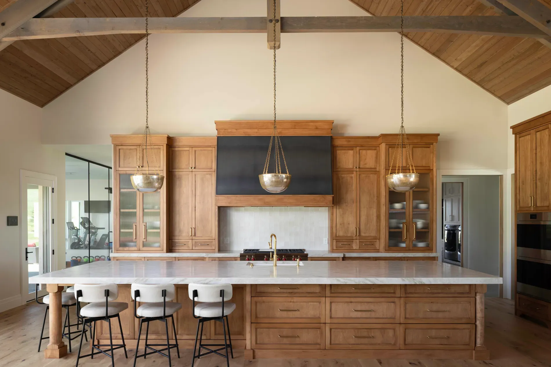 Big island moment — marble with gentle veining. Seating looks ready for a crowd.