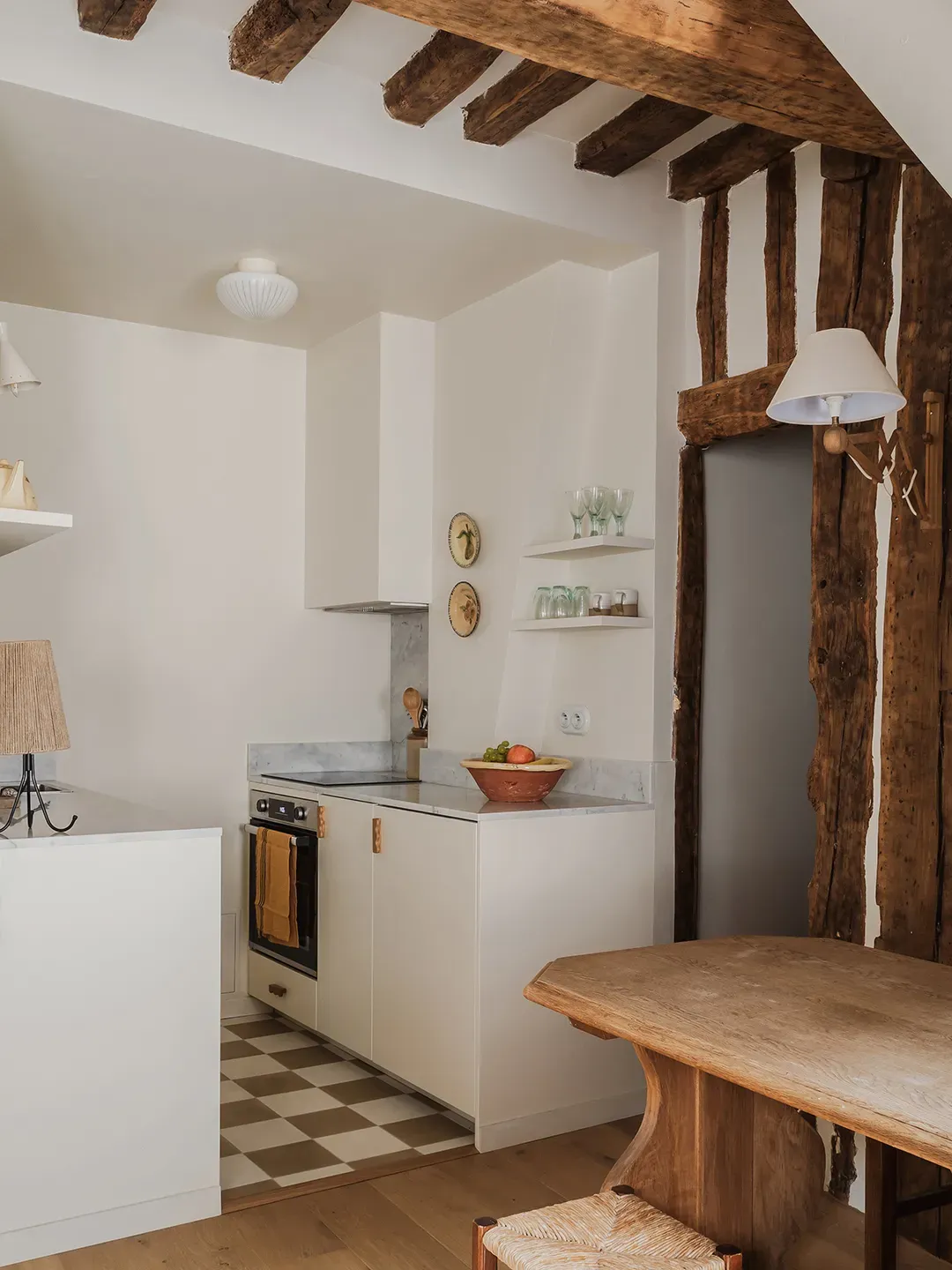 And then kitchen goes rustic-meets-modern — beams with cream cabinets. Cute, maybe a bit?