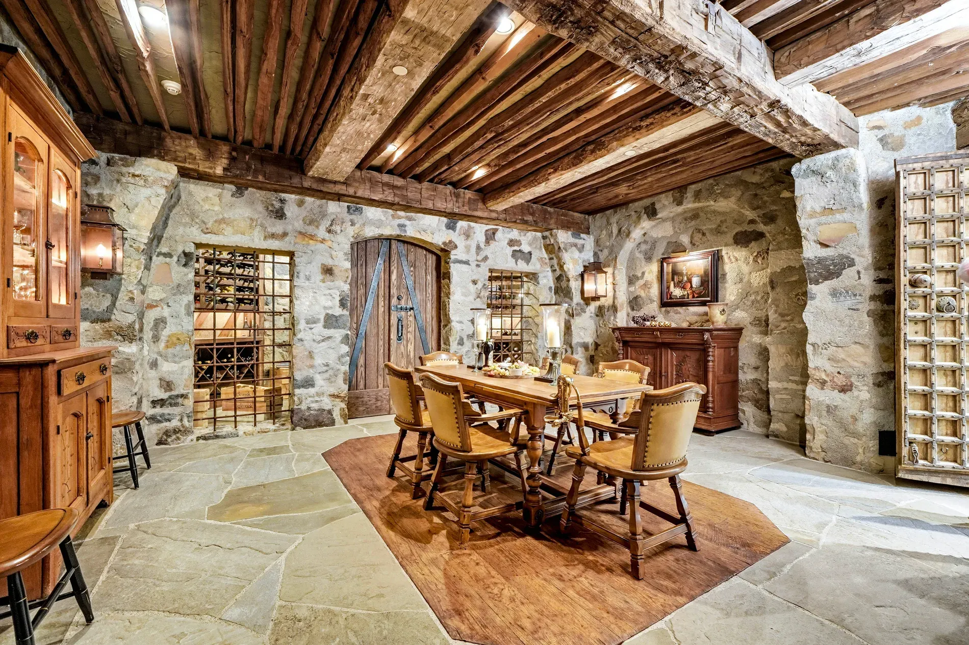 Medieval-ish dining zone. Stone walls, chunky beams, surprisingly bright.