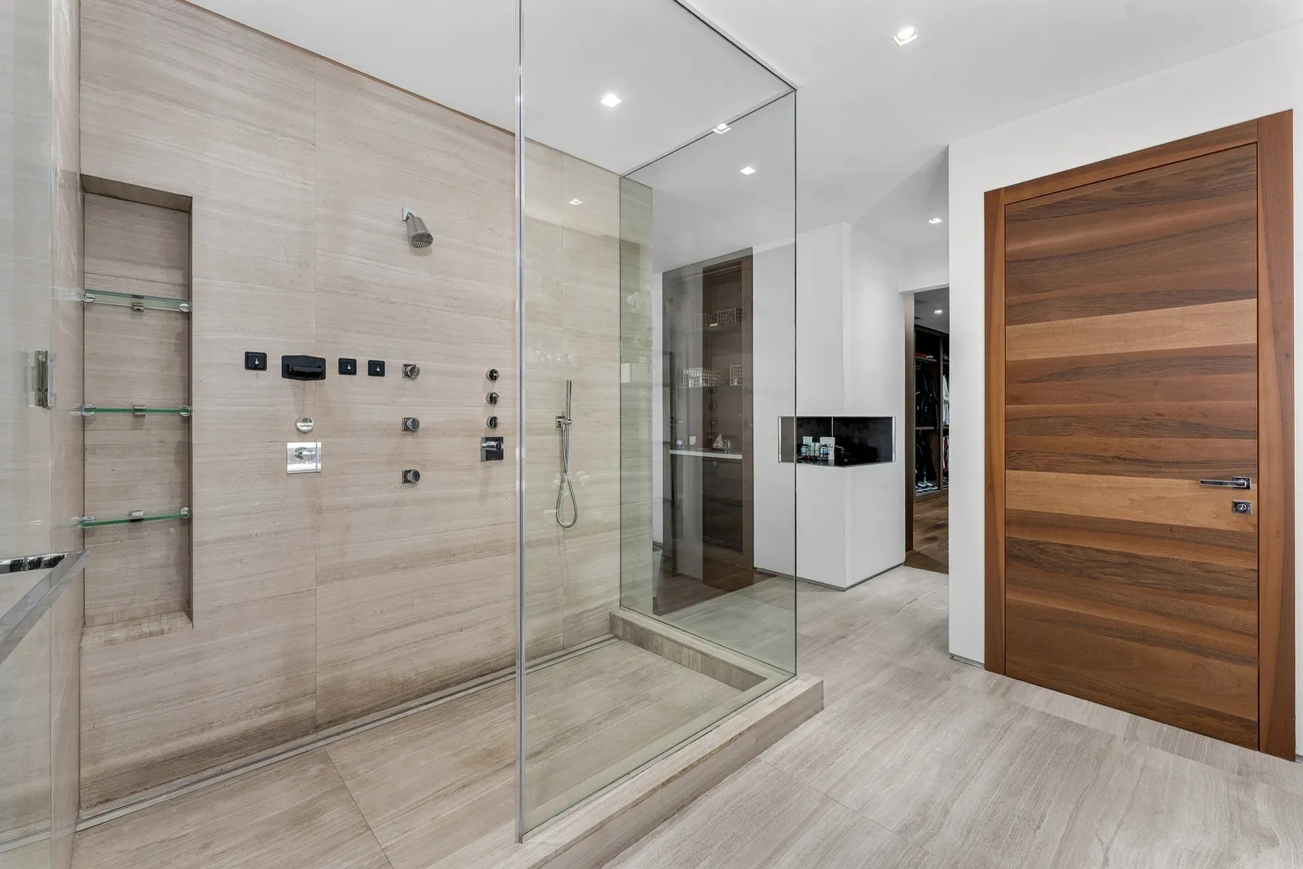 Shower goals — beige stone, big glass. Spa vibes without trying.