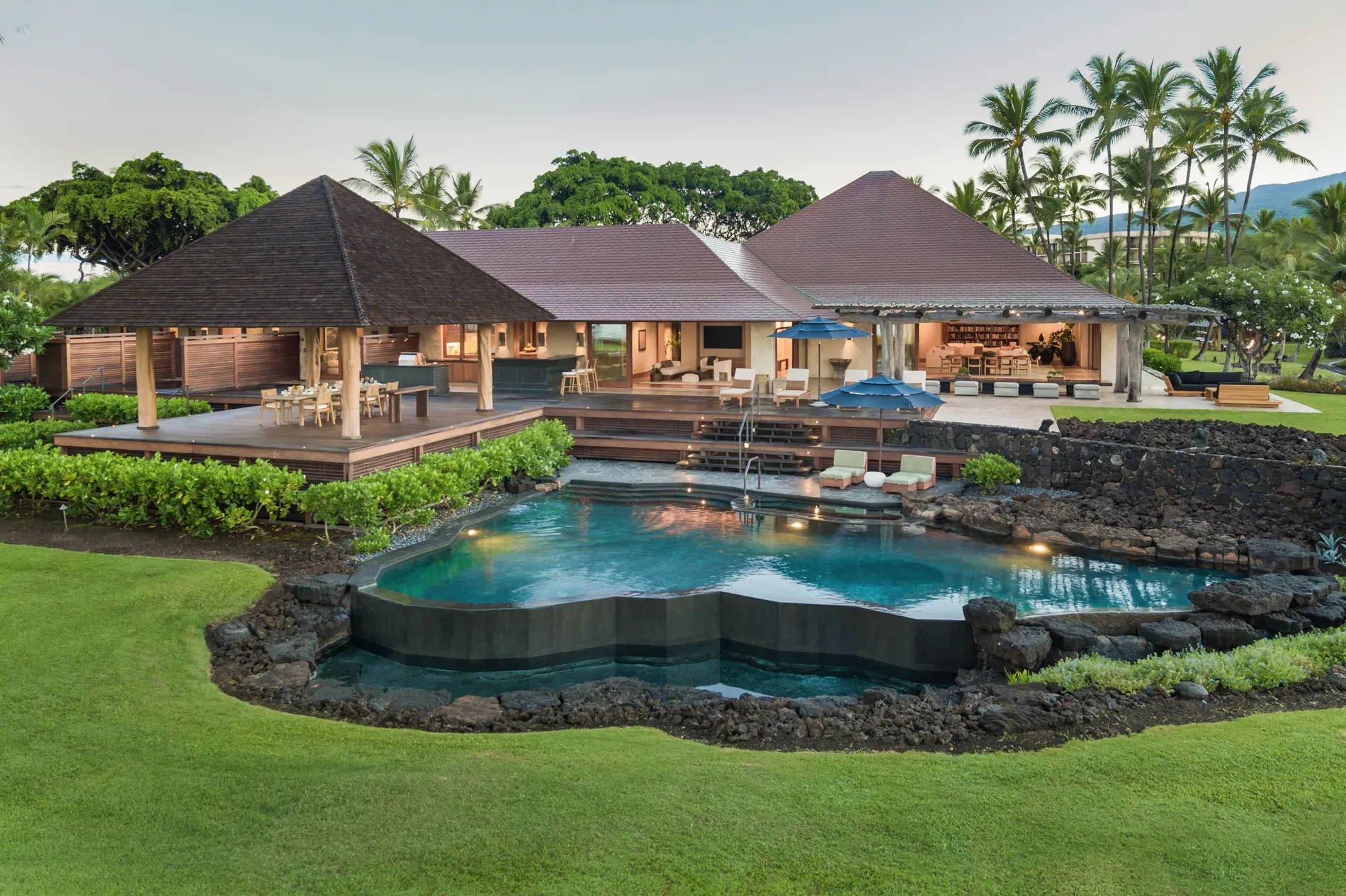 Here's the villa — open walls, dark timber roof, jungle just pours in.