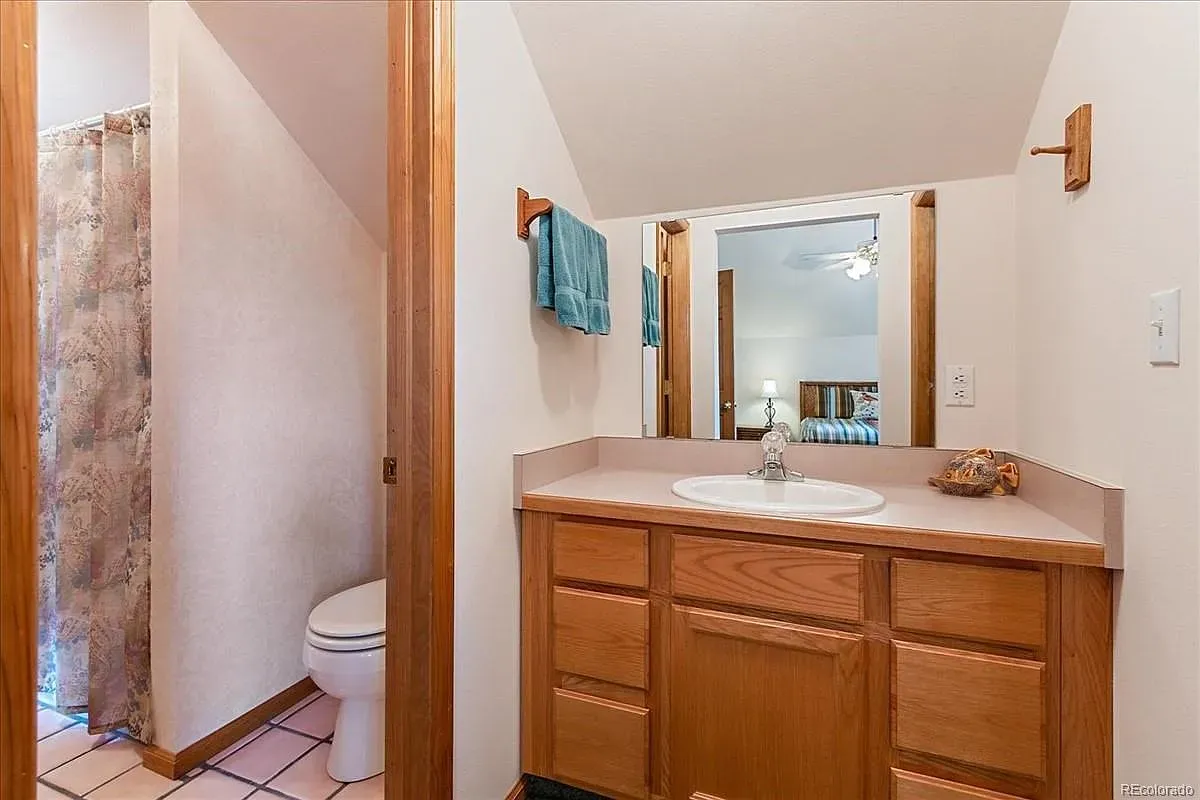 And then a simple bathroom—beige walls, light tile, practical.
