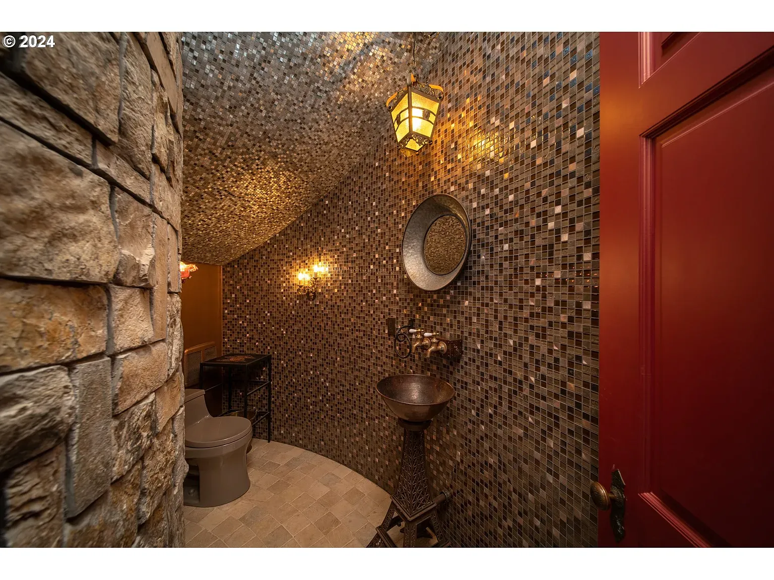 Mosaic wall in golds and browns, curved ceiling. Spa cave energy.
