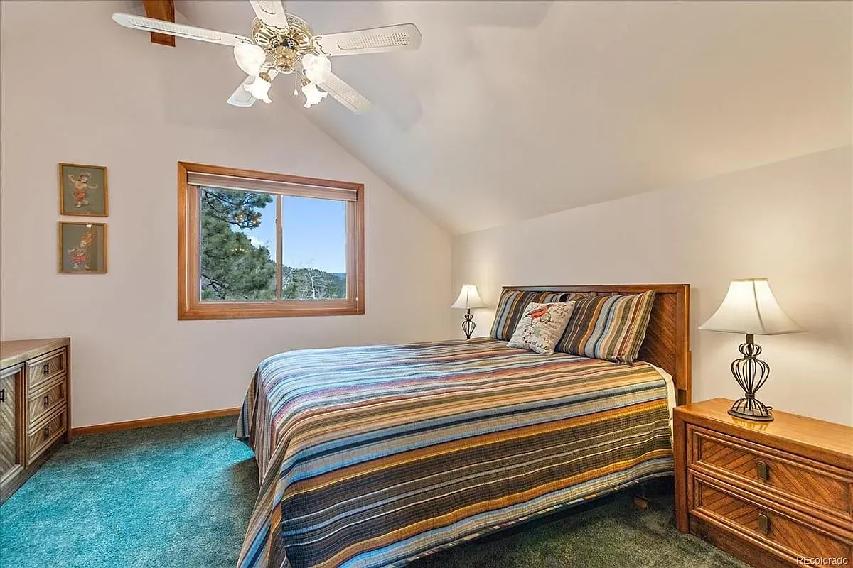 From the bed, that sloped ceiling feels snug, big window steals the show.