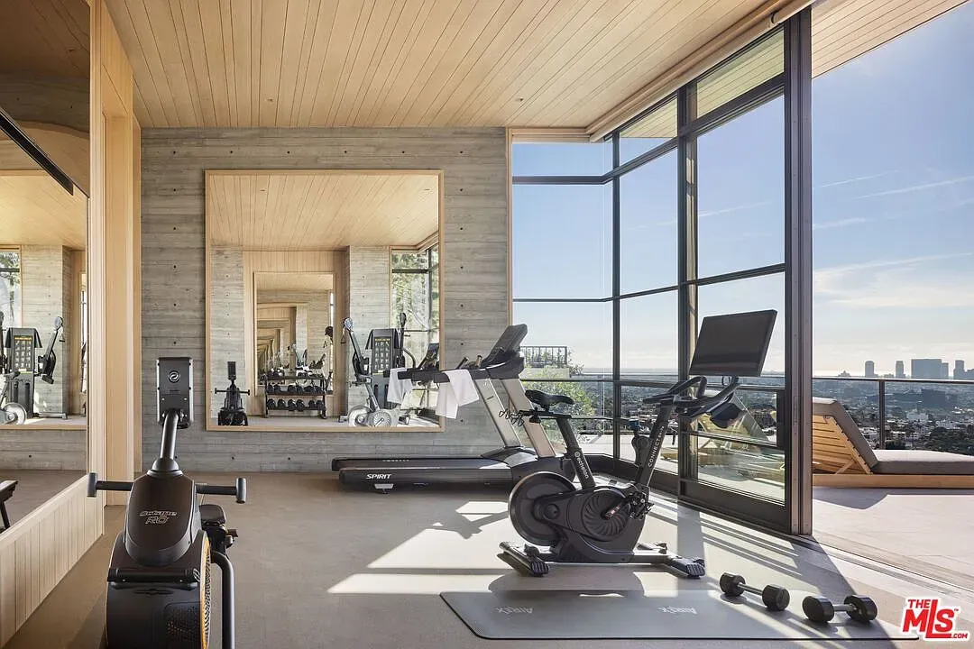 Home gym with full-height windows. Imagine squats with that view. Motivation unlocked.