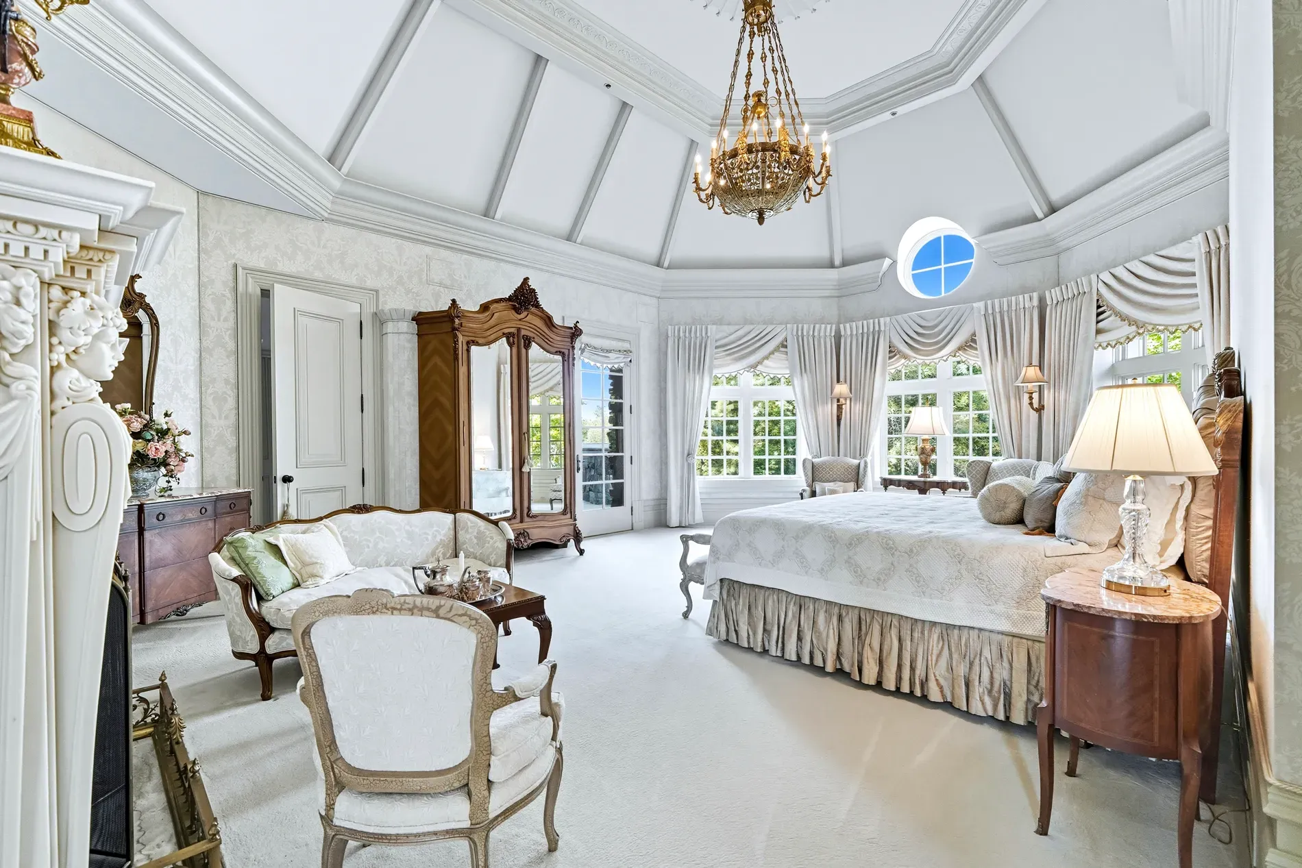 Primary bedroom goes full palace. Molding everywhere, chandelier doing the most. Why so extra?