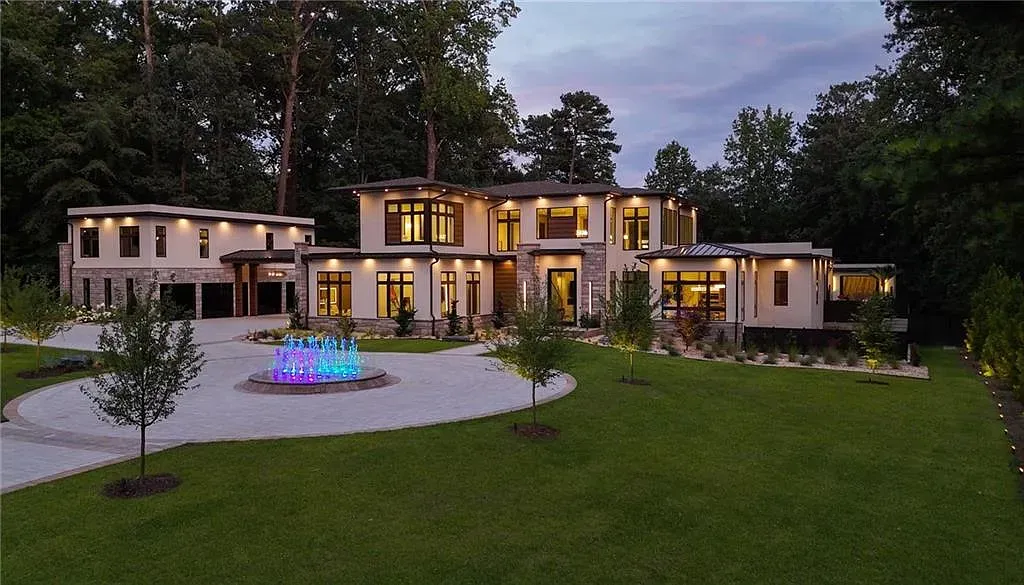 Here's the front — clean stucco, big glass, landscaping doing heavy lifting.