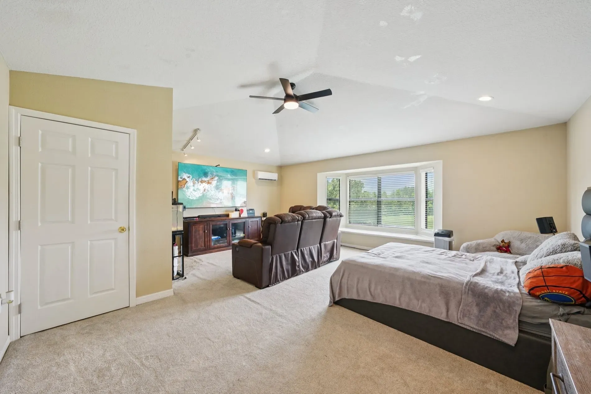 Master with a bay window moment. Soft beige everything, super nap-friendly.