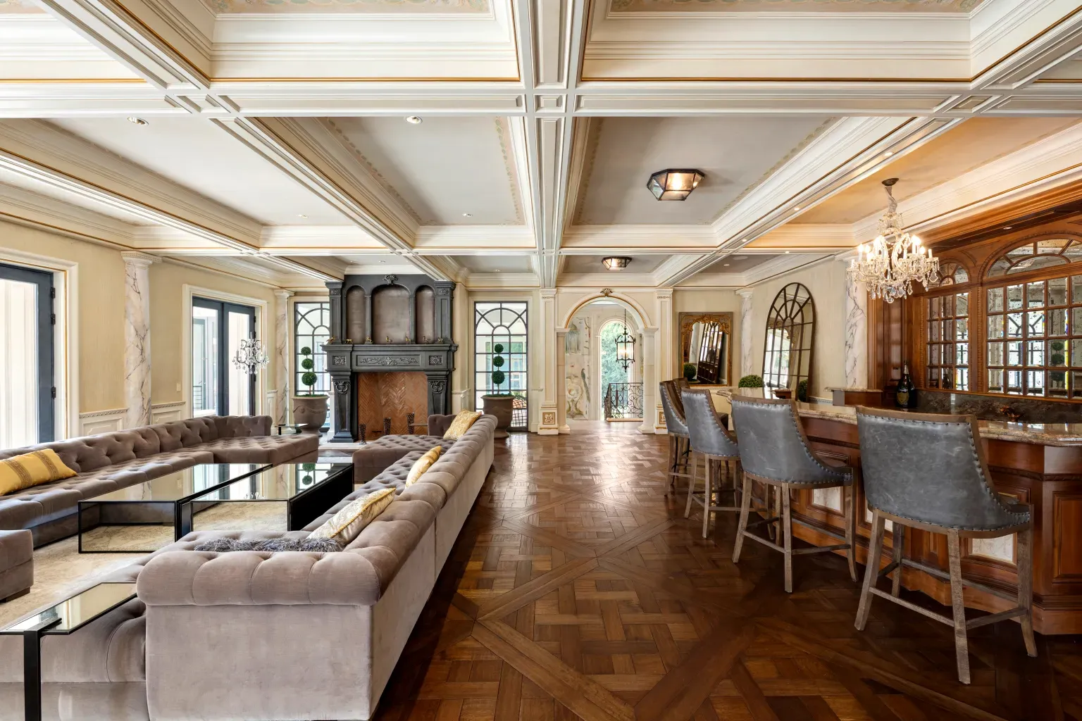 Parquet geometric floor steals it. Neutral seating keeps it simple.