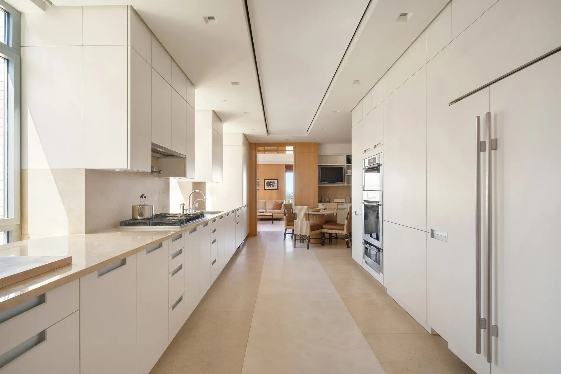 Here's the kitchen — all creamy cabinets, super bright. Where do the fingerprints go?