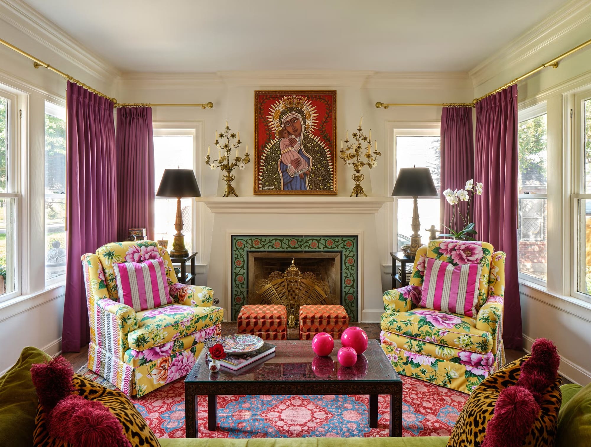 Two giant floral chairs plus striped pillows—chaos, but kinda charming.