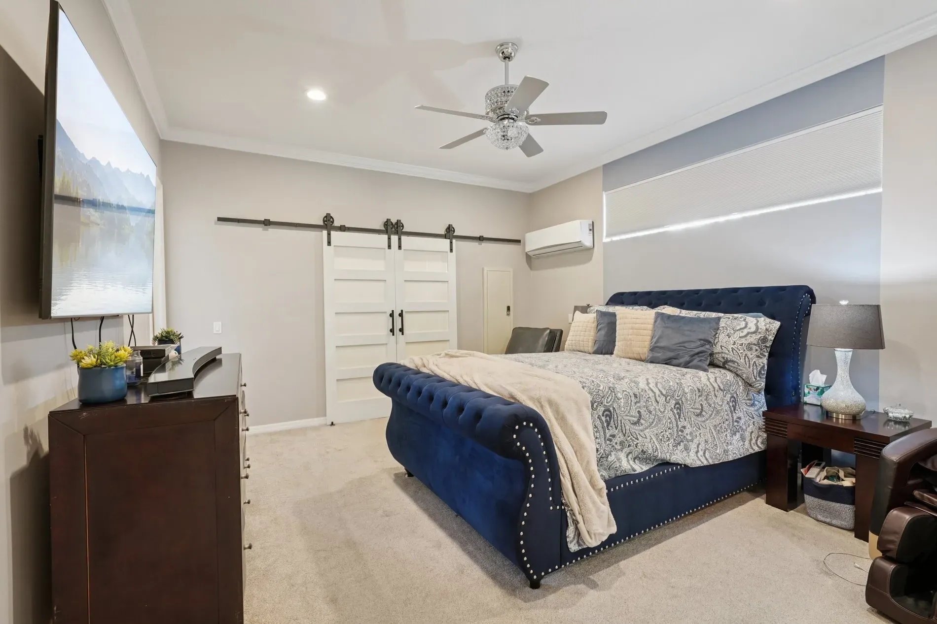 Navy tufted bed steals the show. Pillows doing a whole choreography.