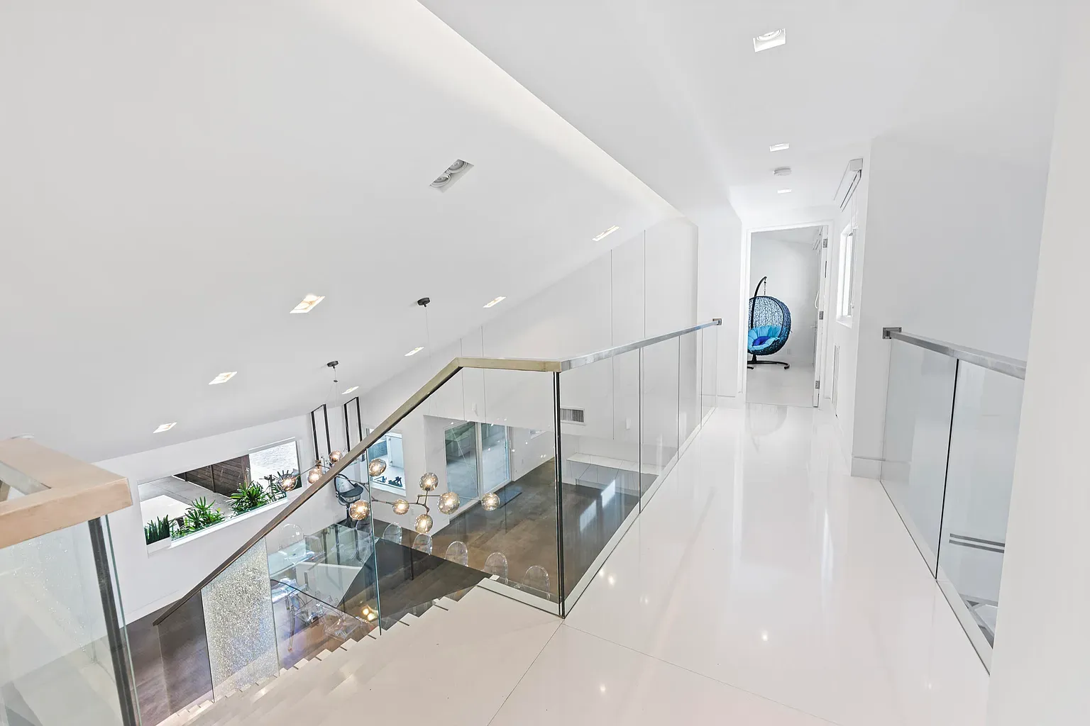 From this angle, the glass railing disappears—just light on shiny floors.
