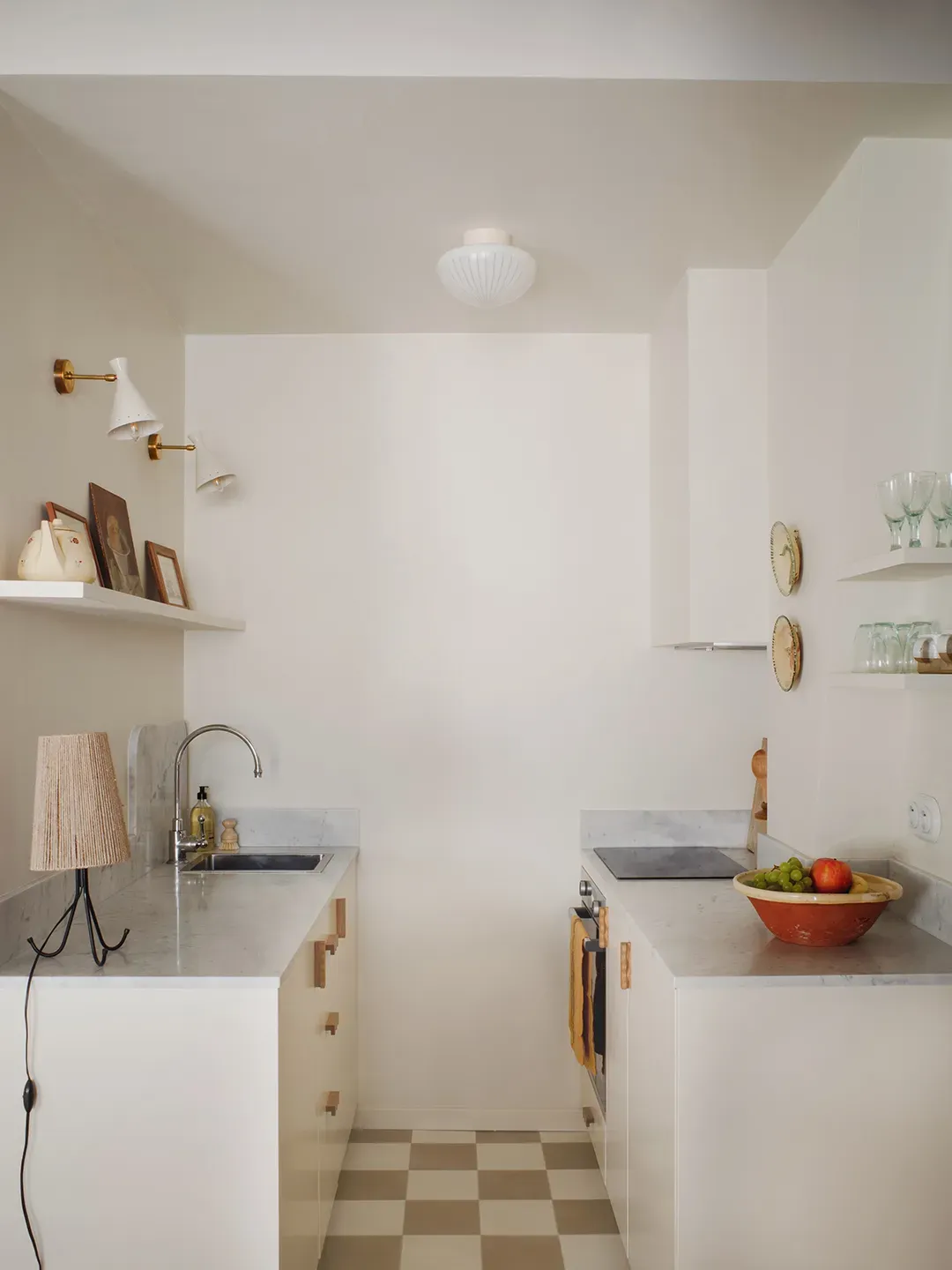 From this angle, the compact white kitchen looks bright. gray counters keep it calm.