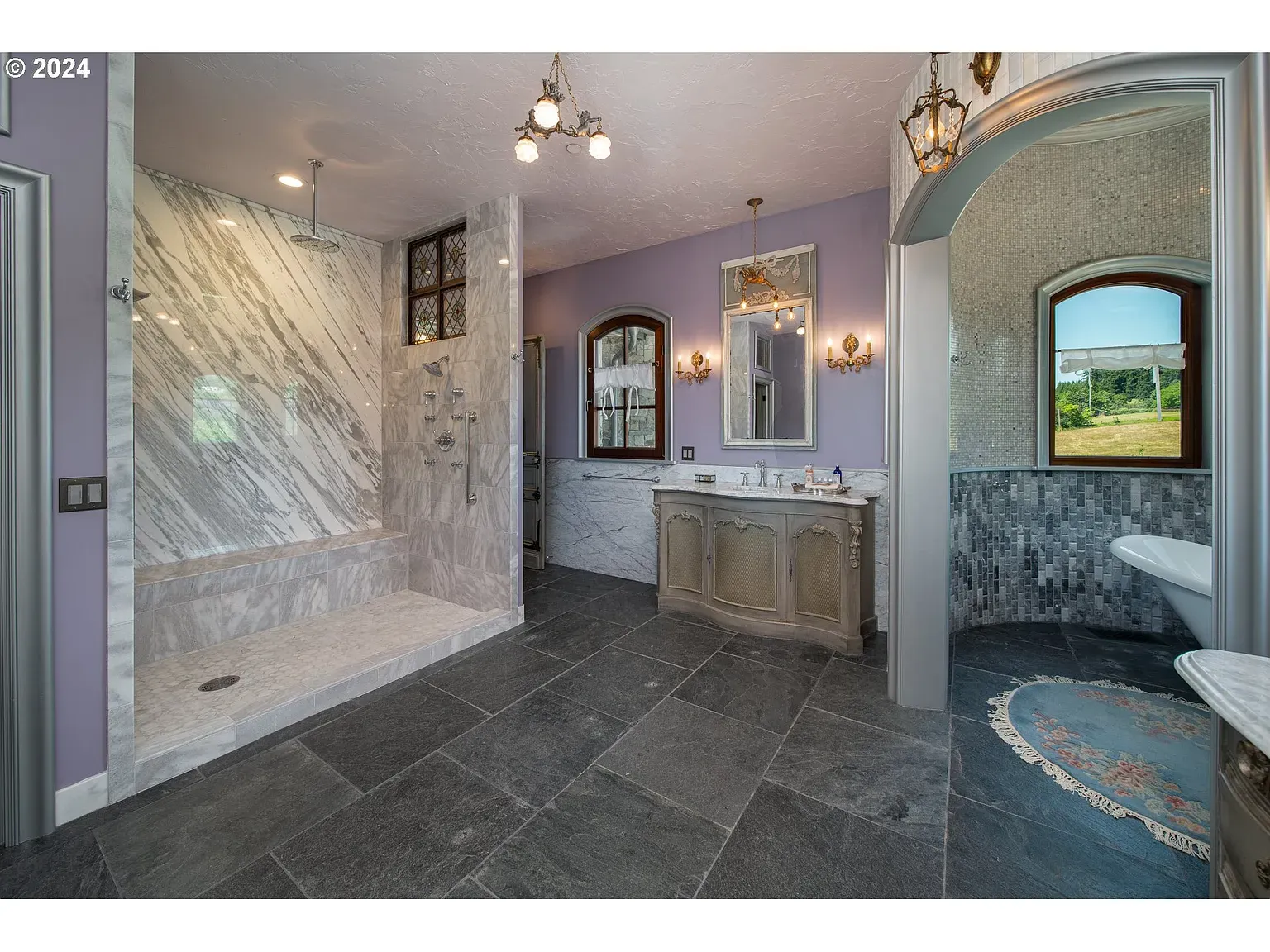 Lavender bath meets big veined marble. Soft plus luxe, nice balance.