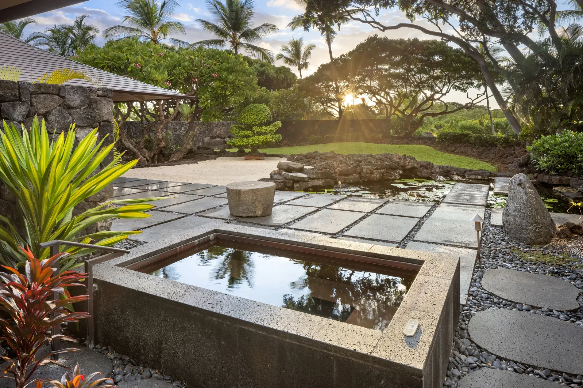 Concrete hot tub, minimal lines, plants doing all the decor.
