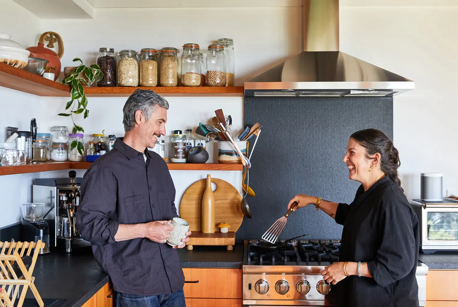 Back to the kitchen—warm cabinets, dark counters. Not sure about the pendants.