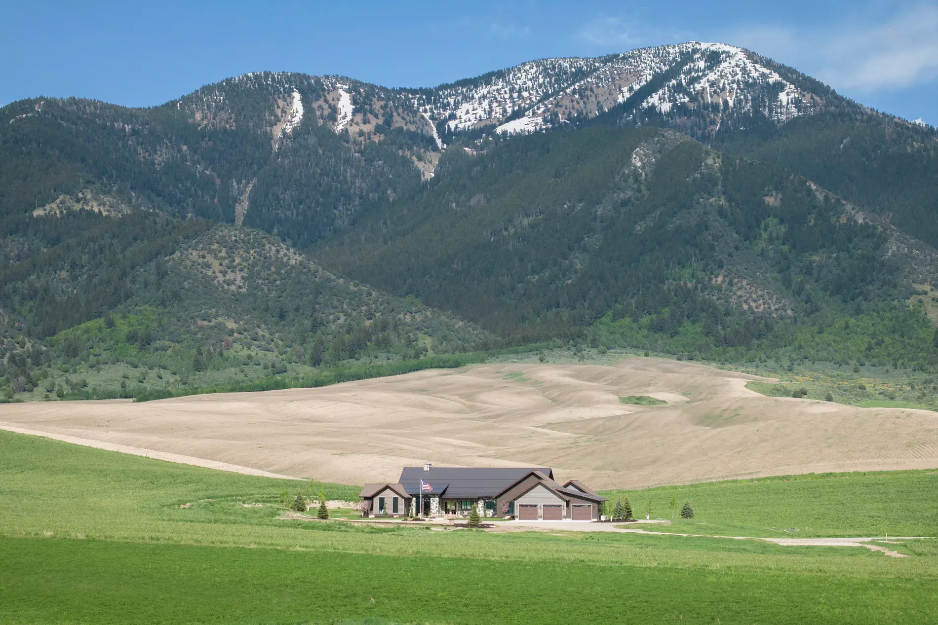 And finally, the house against the mountains. Low roofline, earthy colors, pretty stealthy.