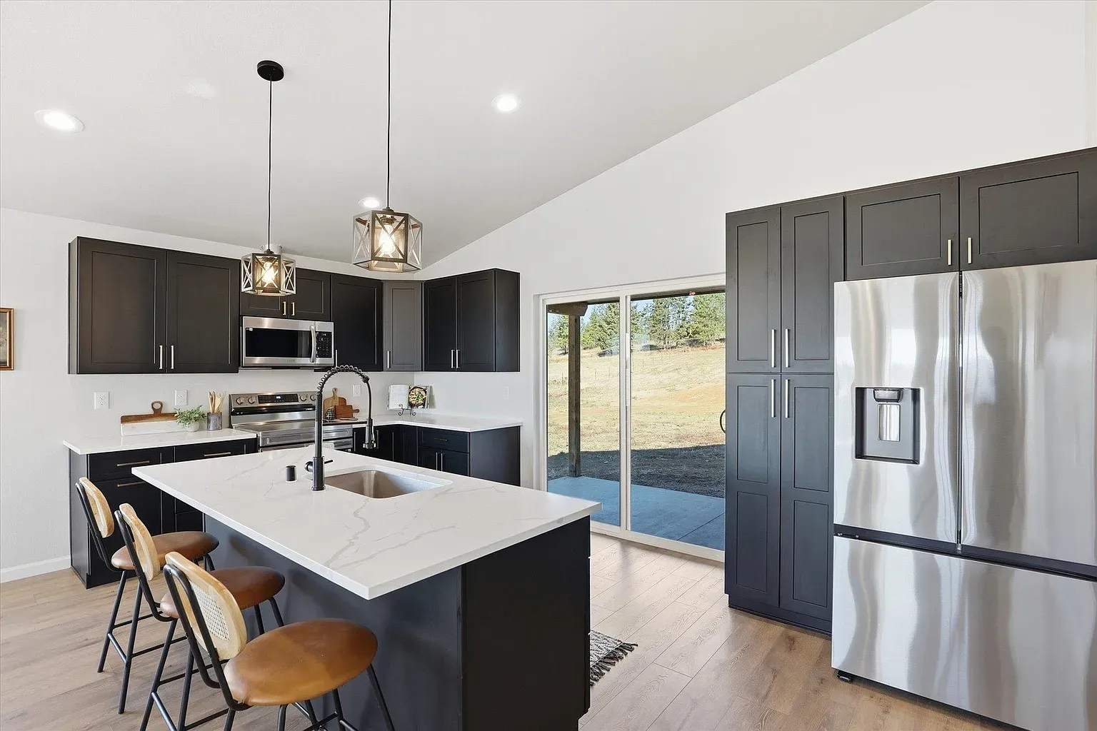 Here’s the kitchen—black cabinets and marble flex. $950k in Washington buys a serious island.