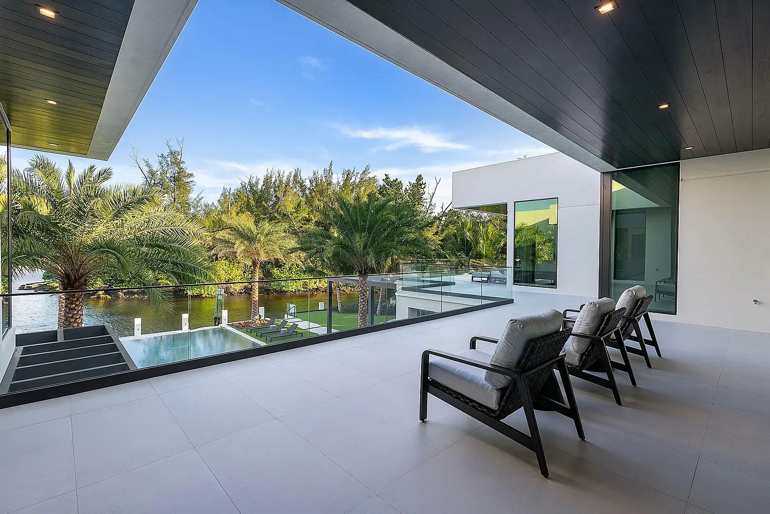 And then this terrace—light stone, dark beams, breezy. Feels vacation-ready.