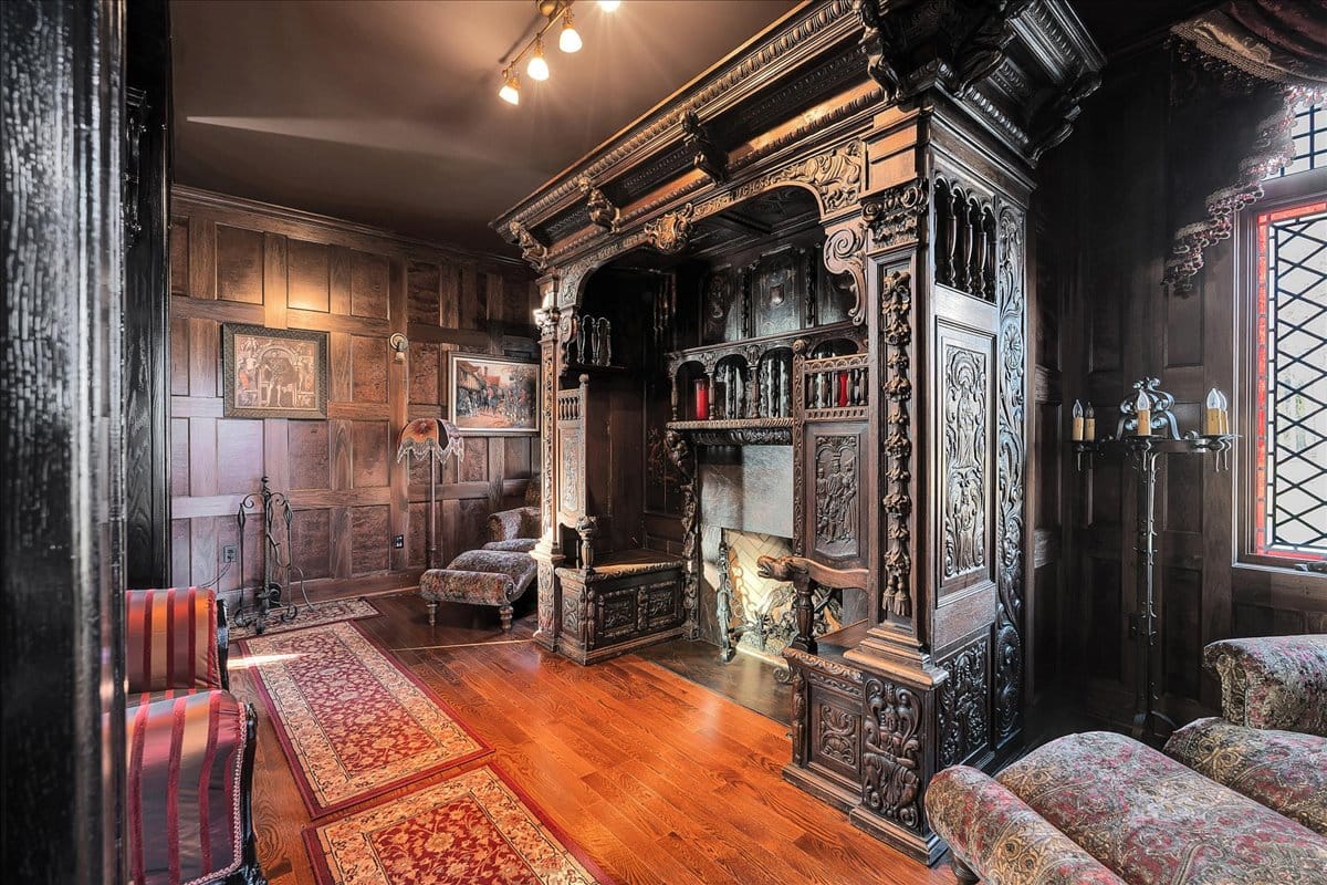 That fireplace carving is intense. Beautiful, maybe too ornate? Not sure about the chairs.