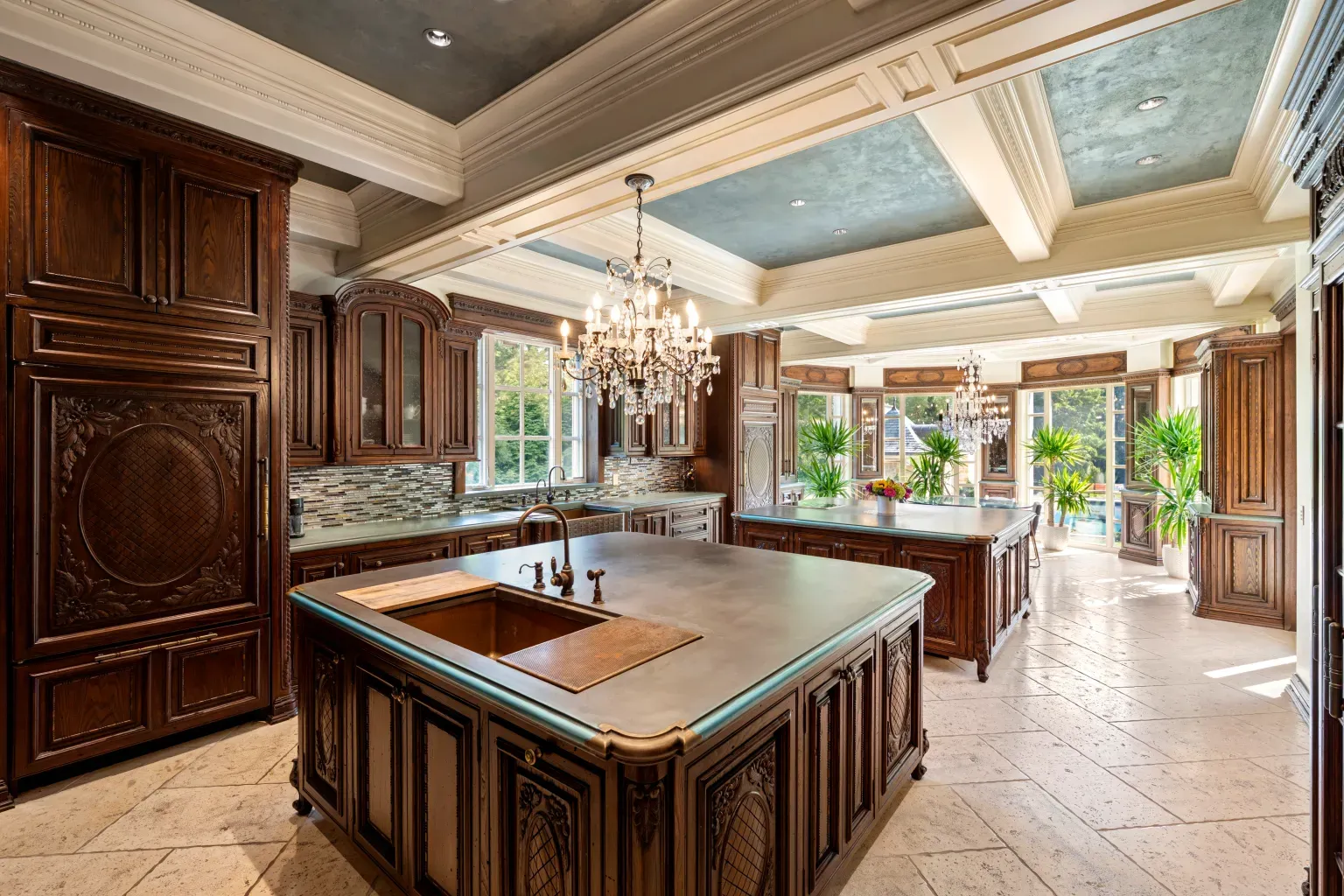 Kitchen. dark carved cabinets, concrete twin islands. Anyone know why this combo?