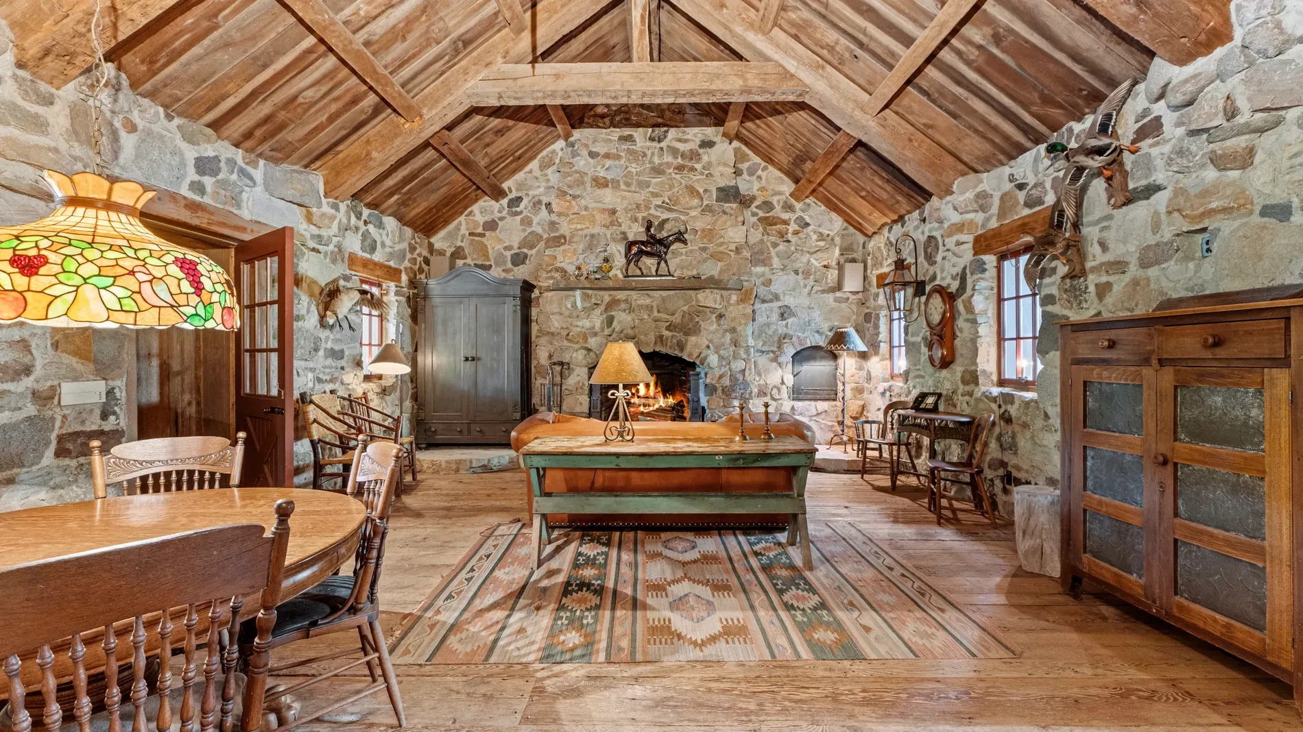 Inside, rough stone walls and huge beams. Feels cave-y but cozy.