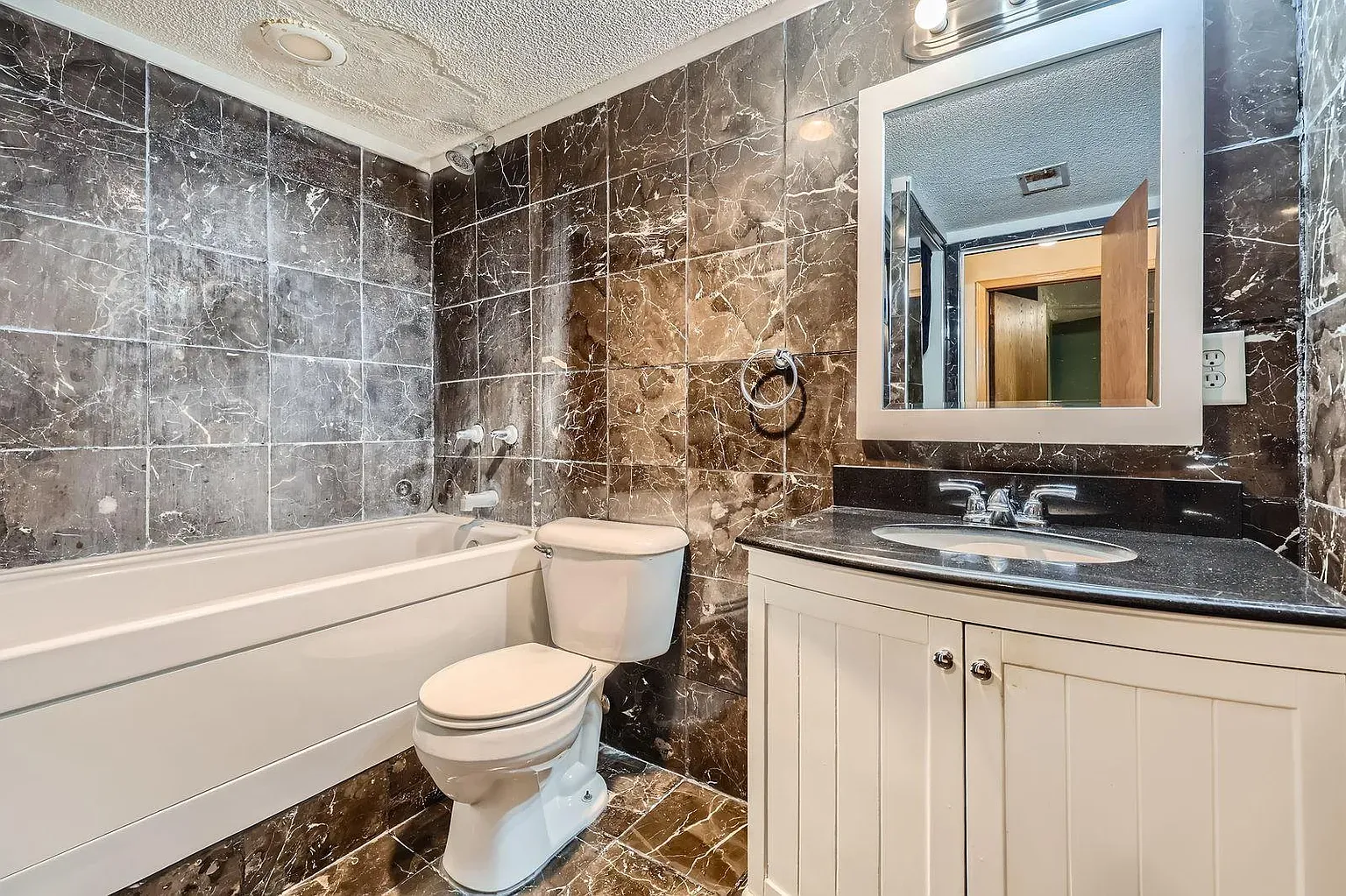 And then—dark marble bathroom. Glossy walls, lighter fixtures, maybe too much?
