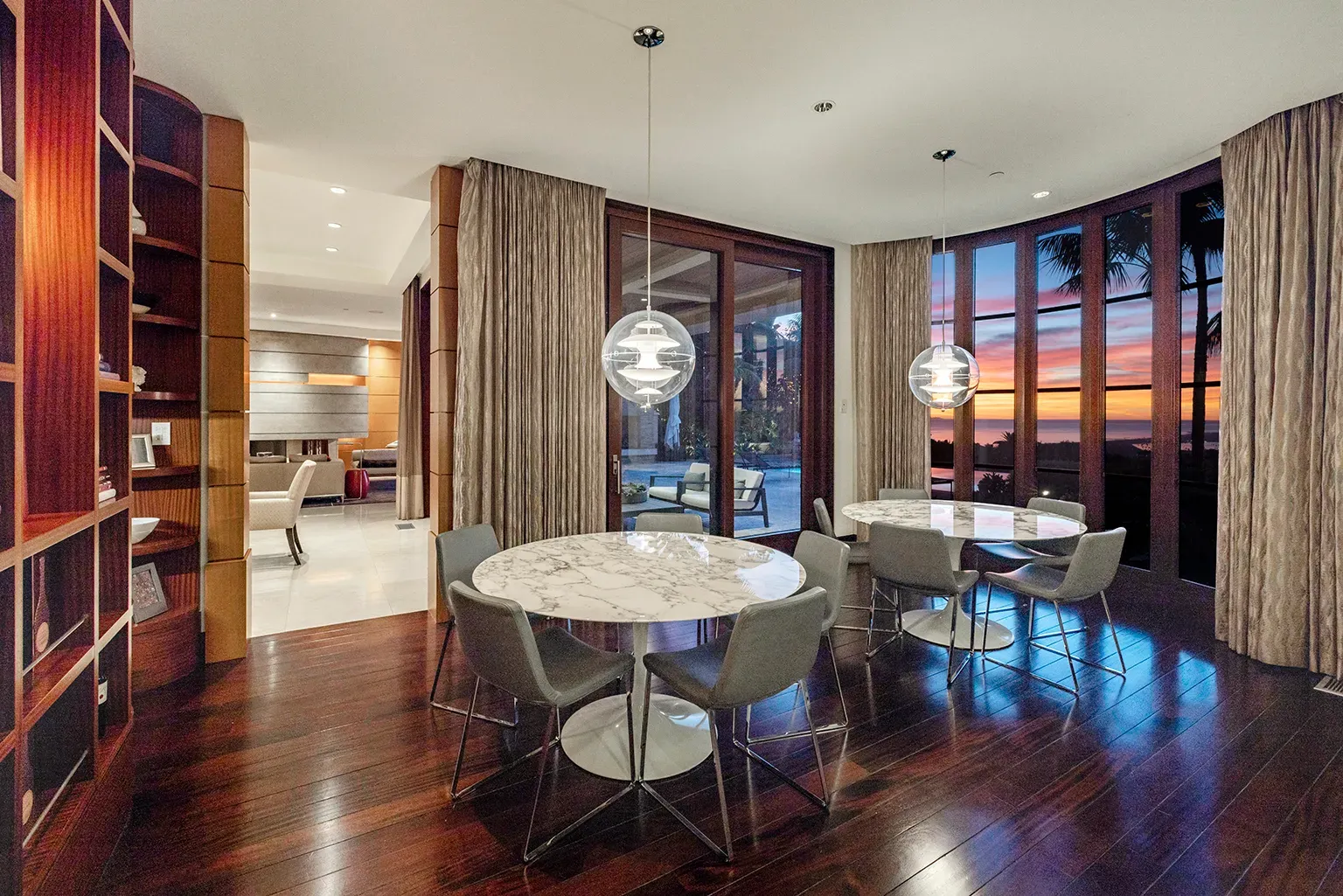 Round marble table steals the shot. Chairs look comfy. Not sure on wall art.