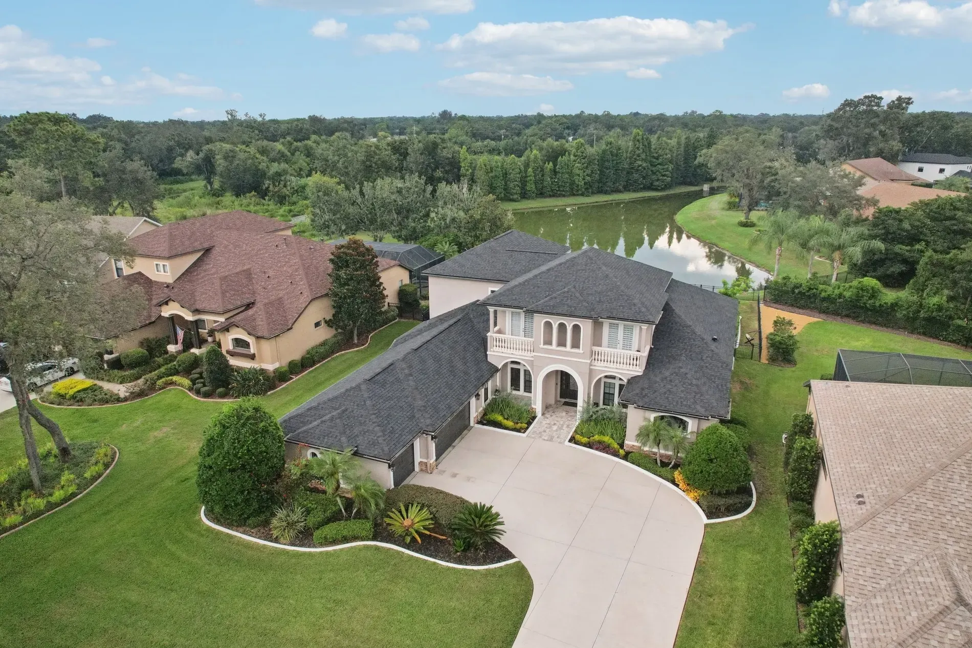 Here's the front — from this angle, Mediterranean vibes and that curved driveway flex.