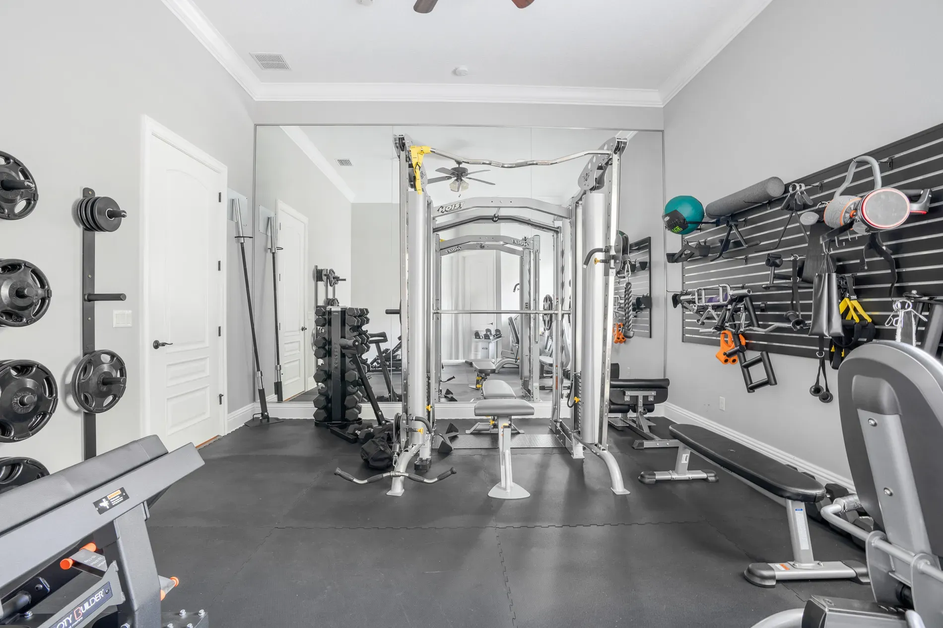 Gym setup—gray walls, huge mirror. Plenty of space to suffer.