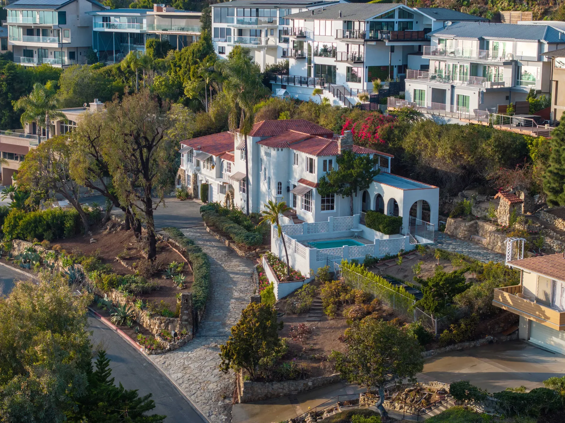 Here's the exterior — whitewashed arches, tile details, and ridiculous views.