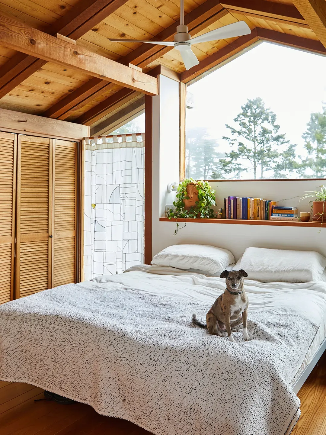 Bedroom with those chunky beams and triangle windows. Morning light must slap.