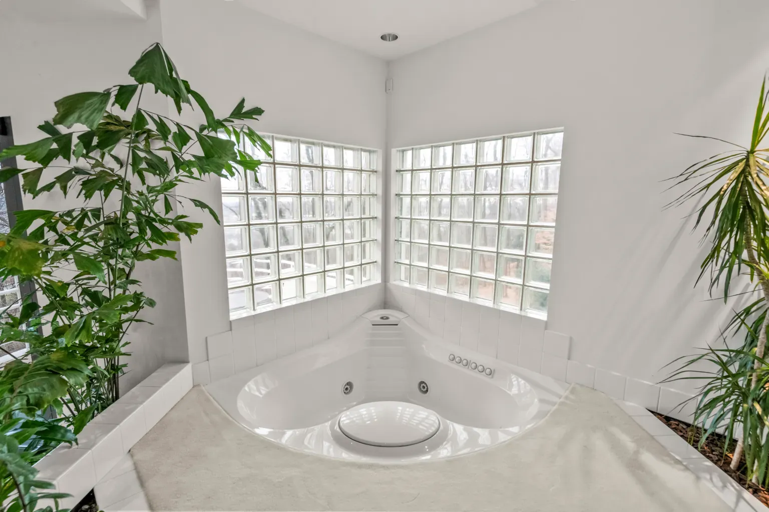 Here's the corner bath — all white and glass blocks. Clean, almost hospital-chic?
