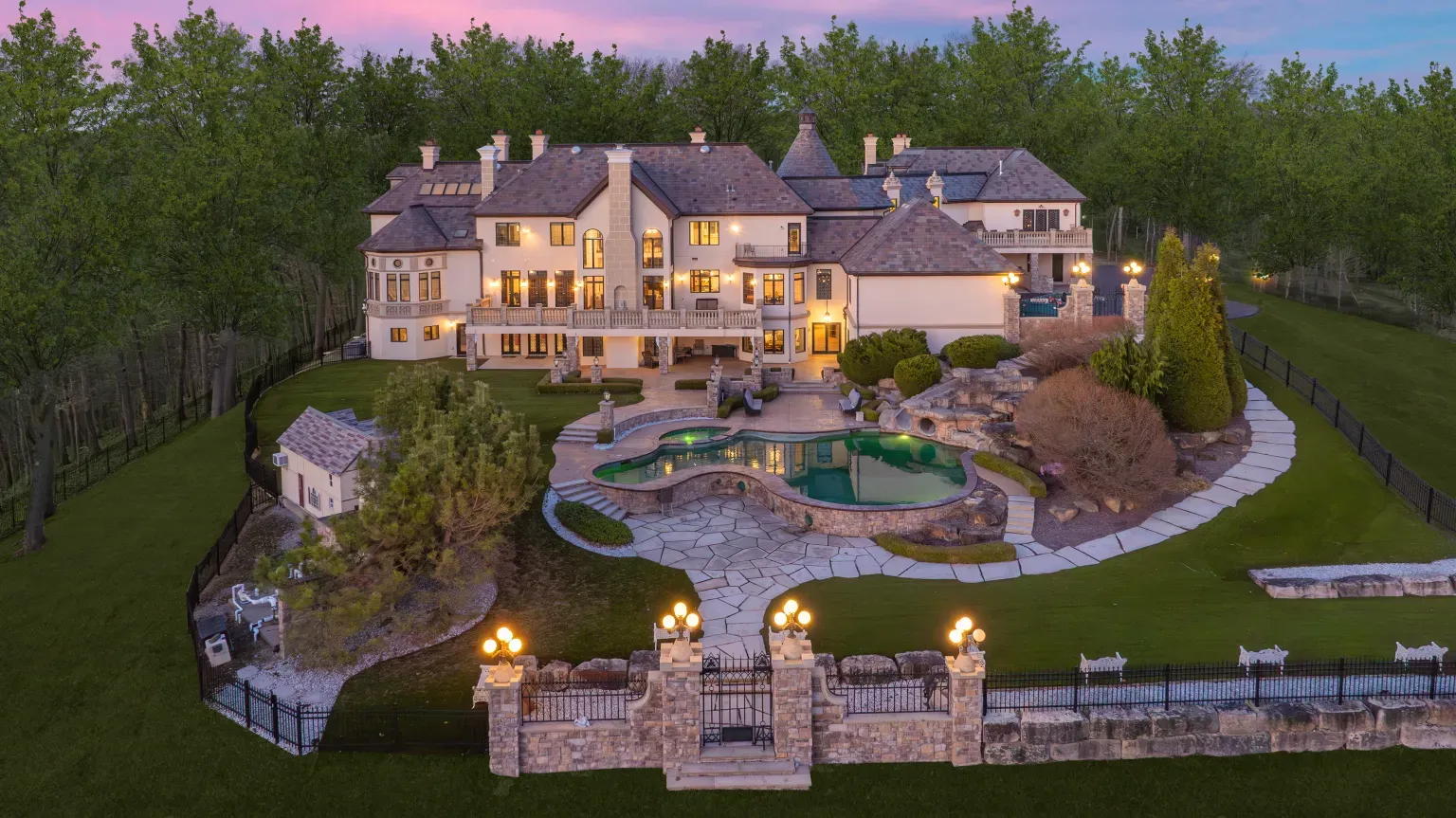 Back outside, from this angle the slate roof pops. Beige stone, lots of gables.