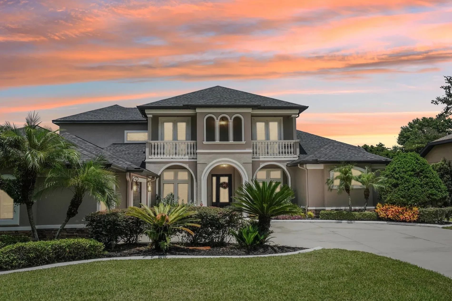 Back outside, smooth modern lines, taupe and white. Landscaping is on point.