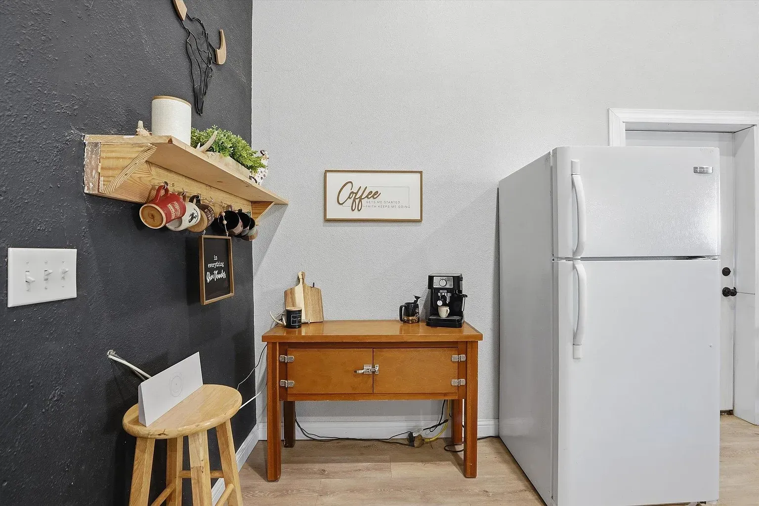 White fridge against charcoal wall goes bold. Not sure about the nook clutter.