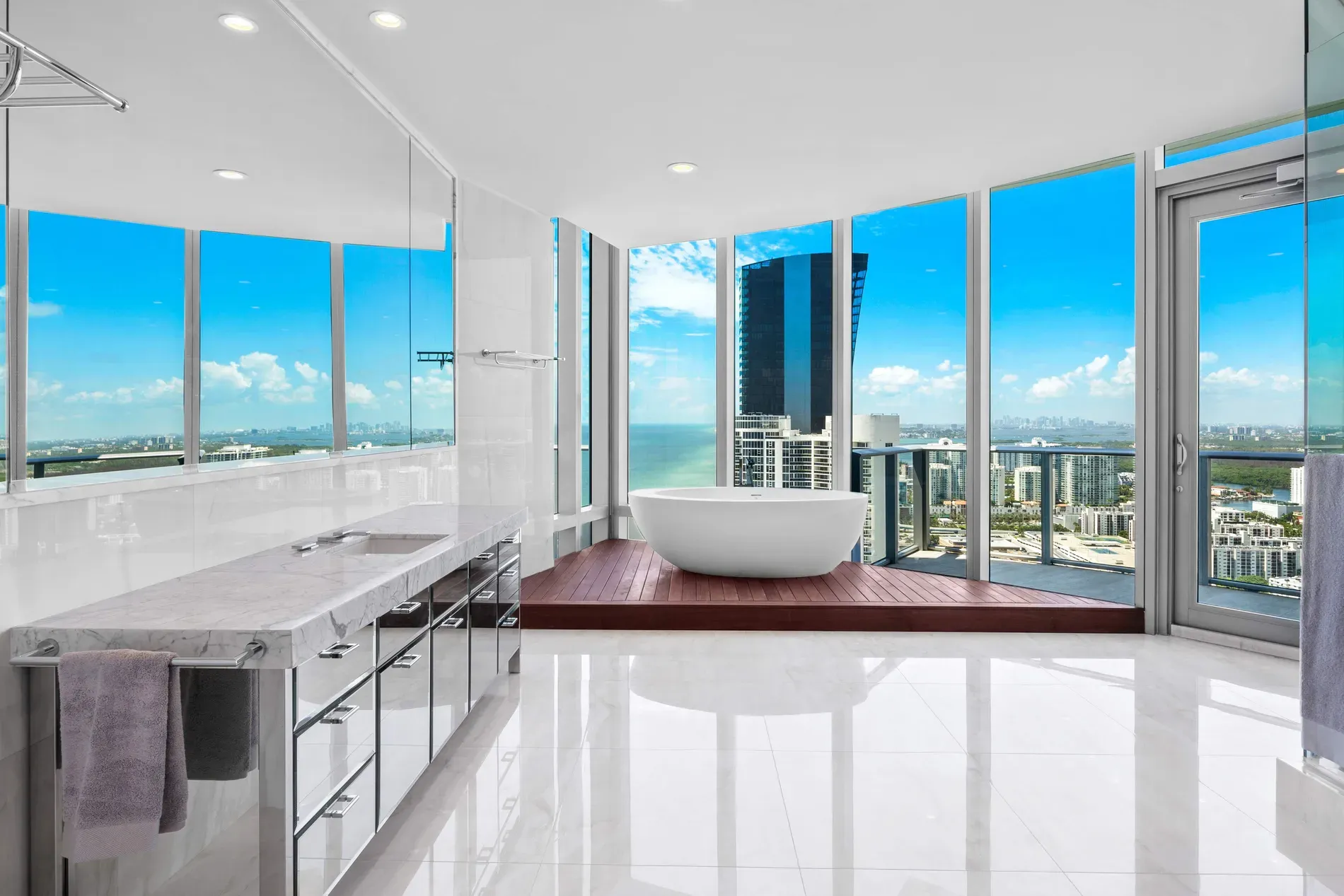 Bathroom flex. marble everywhere, city and water peeking in.