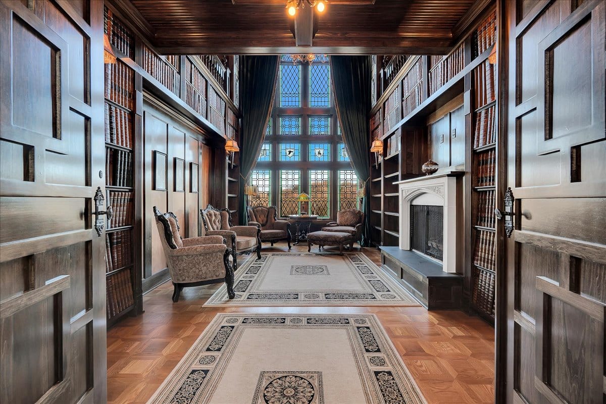 Here’s the library. Massive carved doors, coffered ceiling overhead. Smells old books.