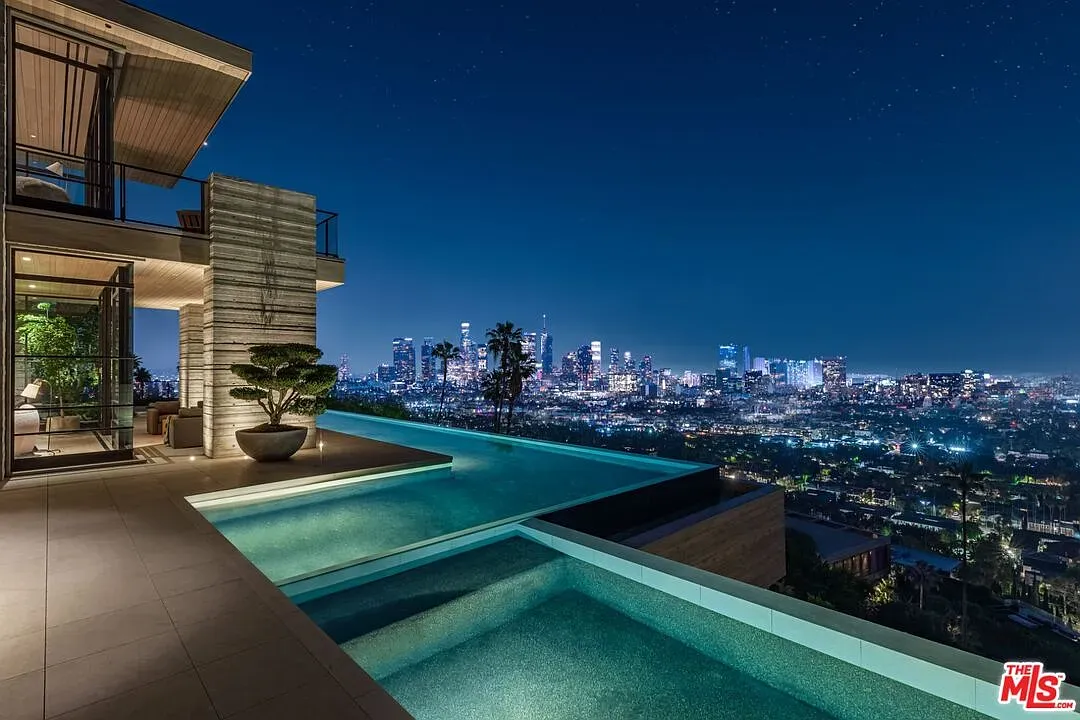 Night shot. infinity pool melts into the city lights. Is the edge real?